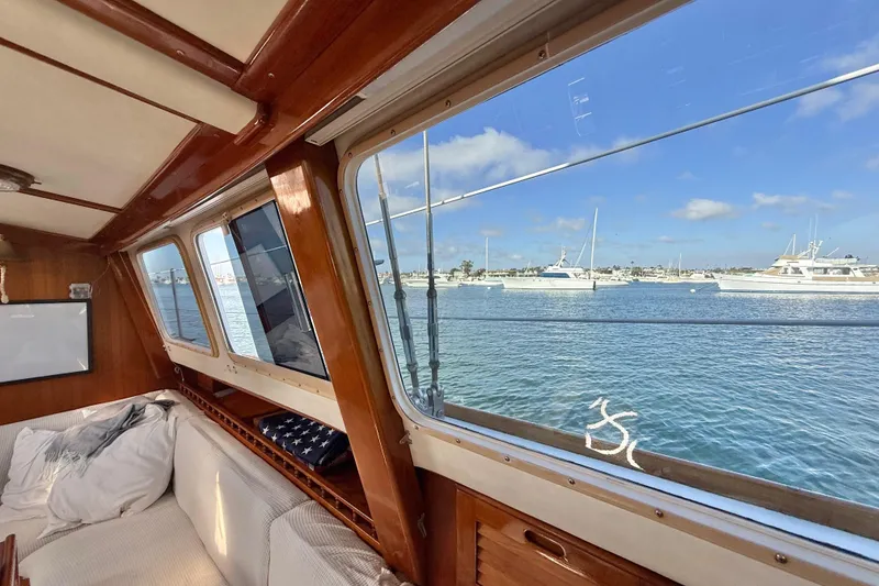 Slide: The Image of Interior view of 1973 CAL 246 boat with ocean and yachts outside window. - 64