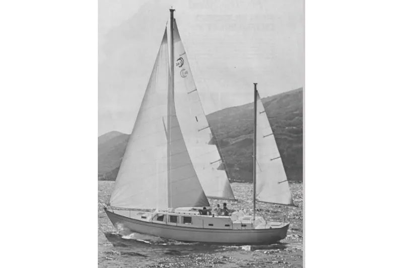 Slide: The Image of Vintage 1973 CAL 246 sailboat navigating scenic waters with hills in the background. - 66