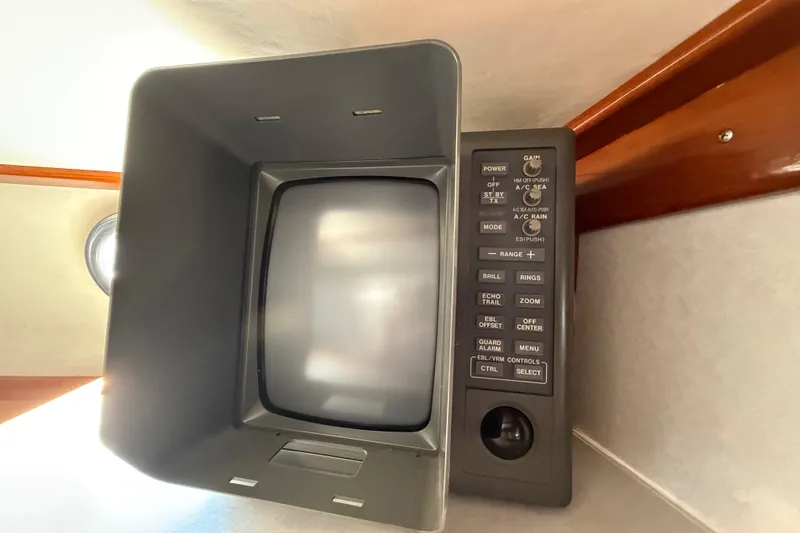 Slide: The Image of Vintage 1973 CAL 246 radar display with control panel in a wooden cabin setting. - 67