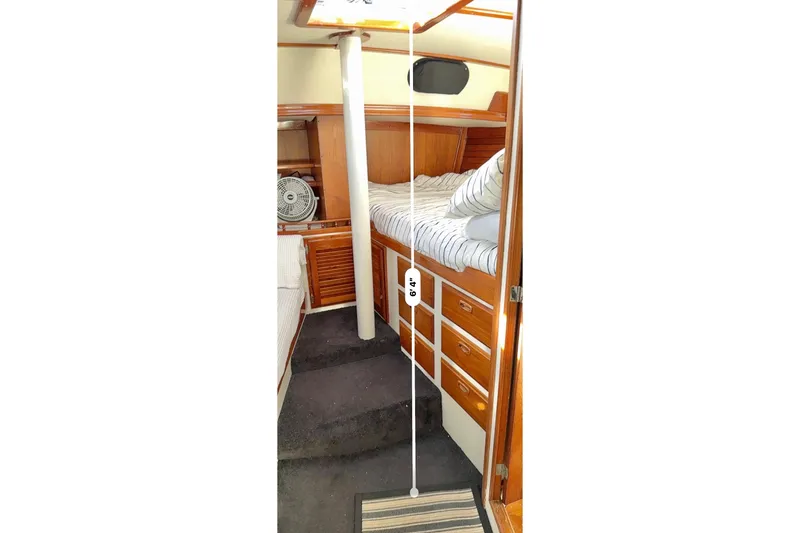 Slide: The Image of 1973 CAL 246 yacht interior with wooden cabinetry and cozy sleeping area. - 77