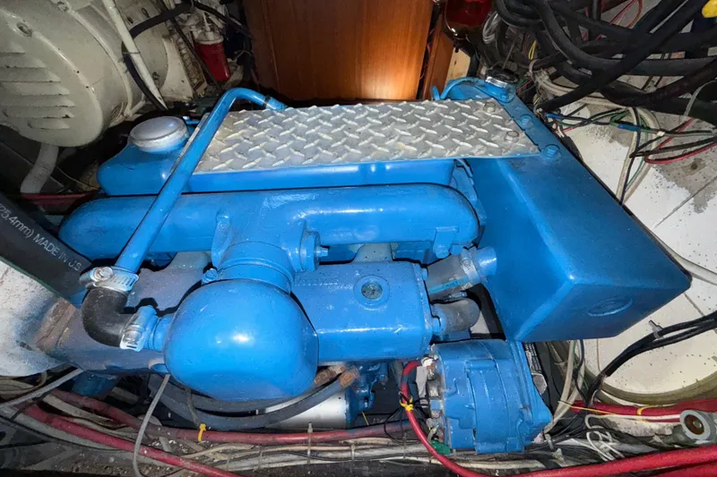 Slide: The Image of Blue engine in a 1973 CAL 246 boat, featuring metal components and wiring. - 80