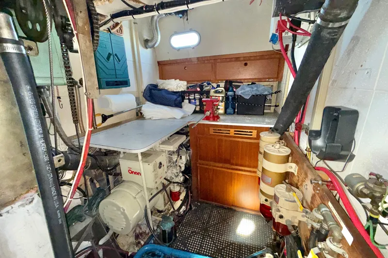 Slide: The Image of Engine room of a 1973 CAL 246 boat with Onan generator and storage cabinets. - 82