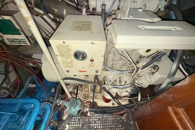 Slide: The Image of 1973 CAL 246 engine room with Onan generator and wiring. - 83