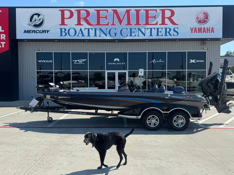 Slide: The Image of 2019 Ranger Z520L boat at Premier Boating Centers with a black dog in the foreground. - 11