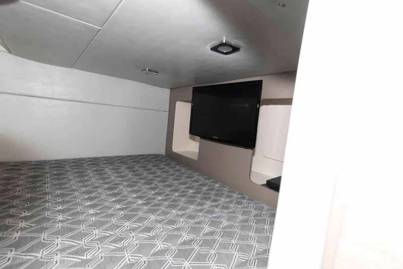 Slide: The Image of 2018 Formula 350 Crossover Bowrider cabin with bed and wall-mounted TV. - 19