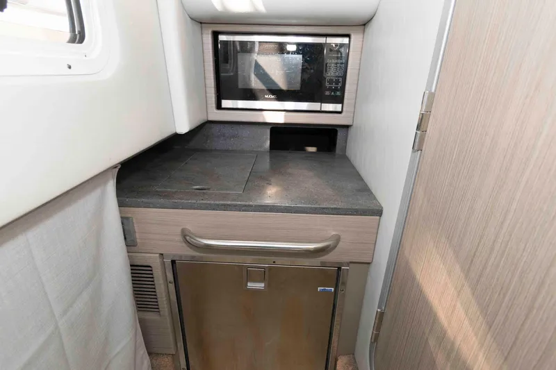 Slide: The Image of Compact kitchenette in 2018 Formula 350 Crossover Bowrider with microwave and mini-fridge. - 20