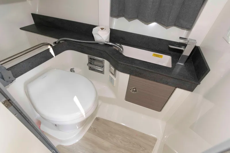 Slide: The Image of 2018 Formula 350 Crossover Bowrider bathroom with modern sink and toilet. - 21