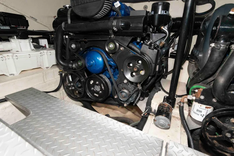 Slide: The Image of Engine compartment of a 2018 Formula 350 Crossover Bowrider boat, showcasing mechanical components. - 24