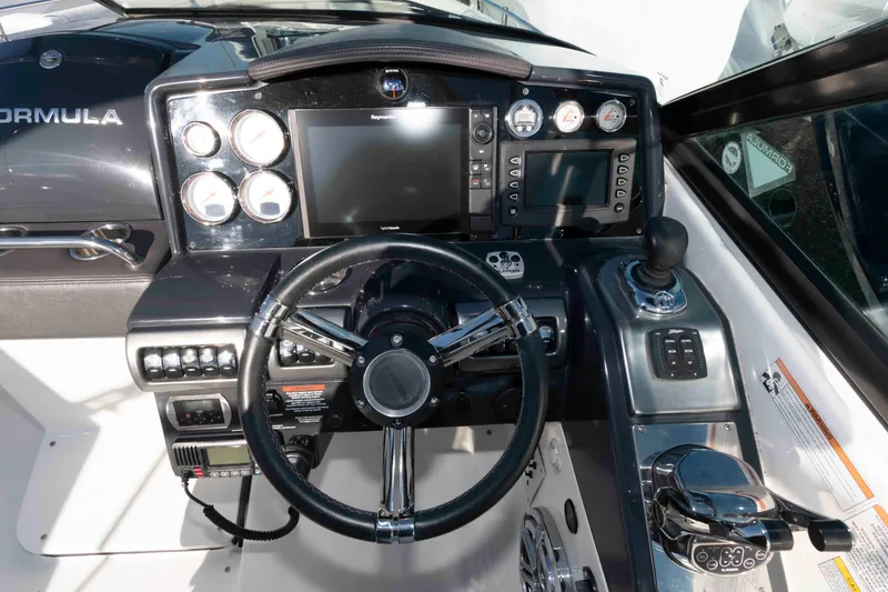 Slide: The Image of 2018 Formula 350 Crossover Bowrider dashboard with steering wheel and navigation controls. - 9