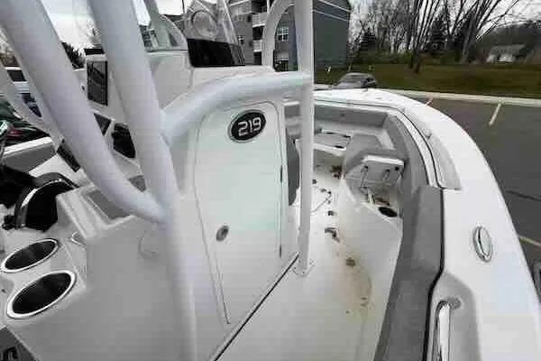 Slide: The Image of 2023 Sea Pro 219 Center Console boat interior with seating and storage. - 11
