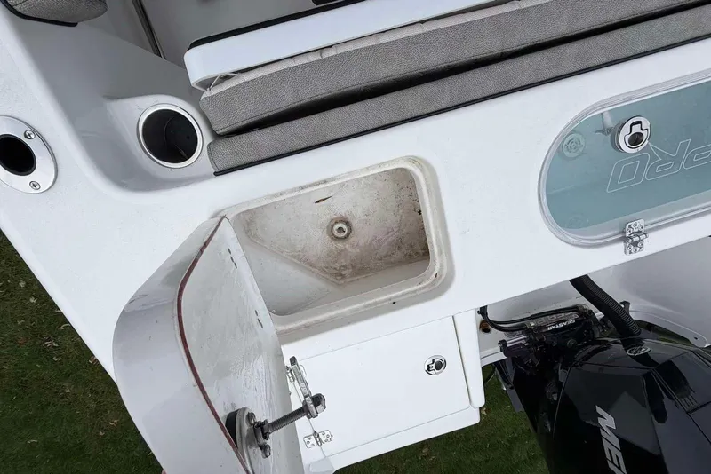 Slide: The Image of 2023 Sea Pro 219 Center Console boat interior with storage compartment and engine. - 14