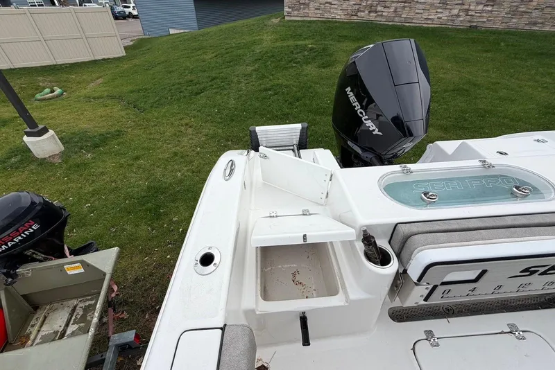 Slide: The Image of 2023 Sea Pro 219 Center Console boat with Mercury engine, docked on grass. - 17