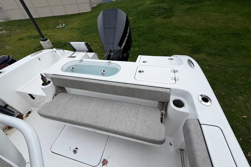 Slide: The Image of 2023 Sea Pro 219 Center Console boat with cushioned seating and outboard motor. - 18