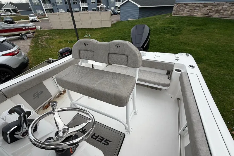 Slide: The Image of 2023 Sea Pro 219 Center Console boat interior with steering wheel and seating. - 19