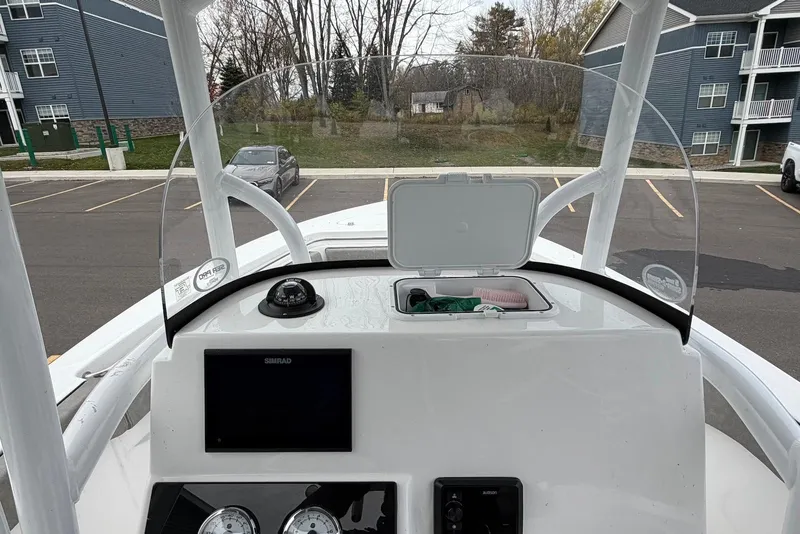 Slide: The Image of 2023 Sea Pro 219 Center Console boat dashboard with navigation equipment and windshield. - 22