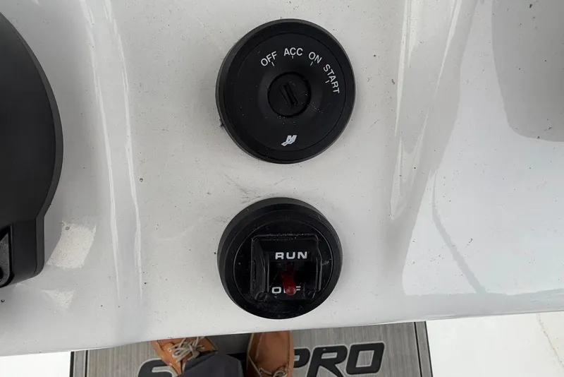 Slide: The Image of 2023 Sea Pro 219 Center Console ignition and control panel close-up. - 25