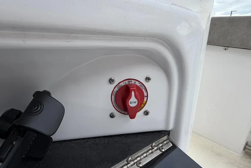 Slide: The Image of 2023 Sea Pro 219 Center Console boat battery switch with red handle. - 27