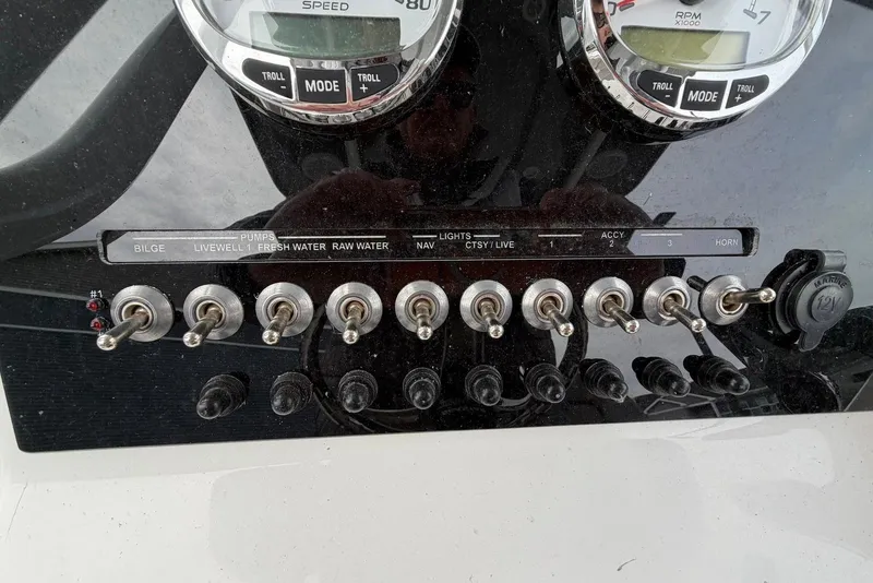 Slide: The Image of Control panel of 2023 Sea Pro 219 Center Console with switches and gauges. - 28