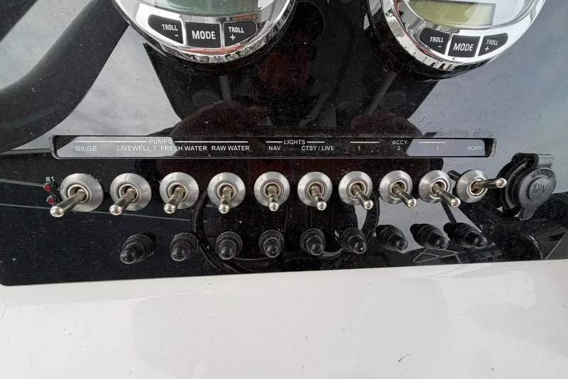 Slide: The Image of Control panel of 2023 Sea Pro 219 Center Console with switches and gauges. - 29