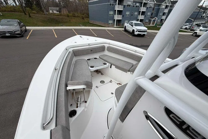 Slide: The Image of 2023 Sea Pro 219 Center Console boat with spacious seating, parked in a lot. - 30
