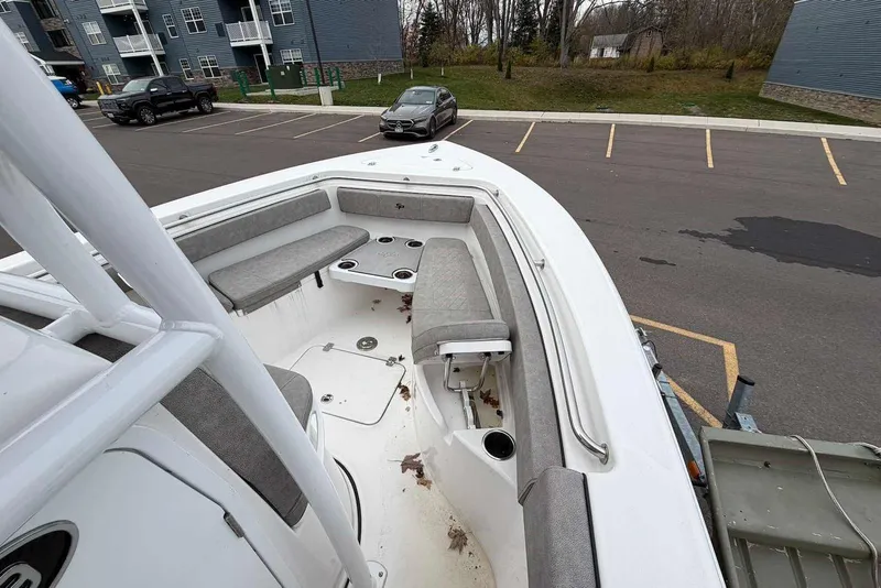 Slide: The Image of 2023 Sea Pro 219 Center Console boat with spacious seating, parked in a lot. - 31