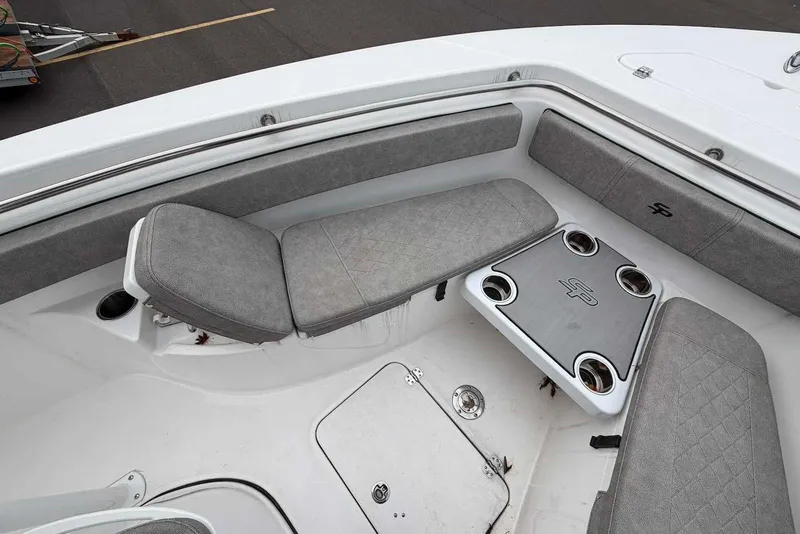 Slide: The Image of 2023 Sea Pro 219 Center Console boat interior with gray cushioned seating and cup holders. - 32