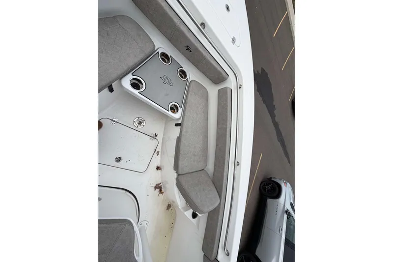 Slide: The Image of 2023 Sea Pro 219 Center Console boat interior with cushioned seating and cup holders. - 35