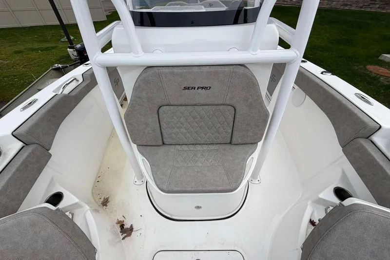 Slide: The Image of 2023 Sea Pro 219 Center Console boat interior with cushioned seating and white framework. - 36
