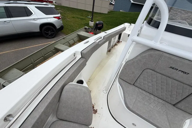 Slide: The Image of 2023 Sea Pro 219 Center Console boat interior with gray seating and white railing. - 37