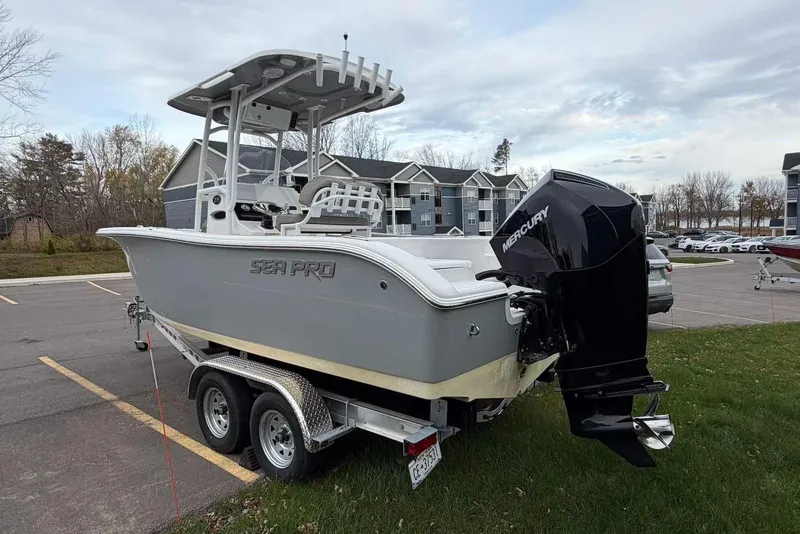 Slide: The Image of 2023 Sea Pro 219 Center Console boat on trailer, parked outdoors with Mercury engine. - 4