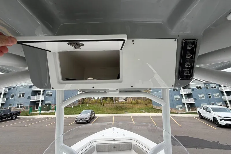 Slide: The Image of 2023 Sea Pro 219 Center Console boat with open storage compartment and control panel. - 41
