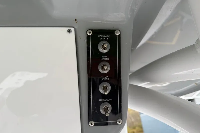 Slide: The Image of Control panel with switches for lights on a 2023 Sea Pro 219 Center Console boat. - 42