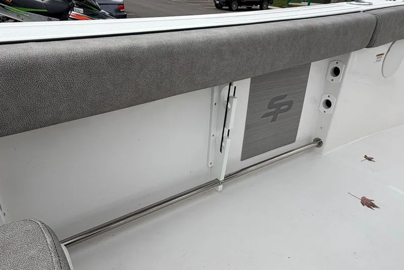 Slide: The Image of 2023 Sea Pro 219 Center Console interior detail with cushioned seating and storage compartment. - 44