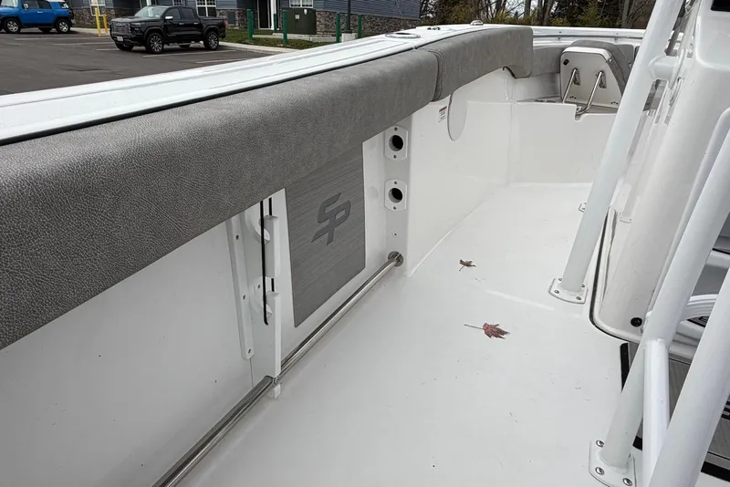 Slide: The Image of 2023 Sea Pro 219 Center Console boat interior with gray cushioned seating and clean white deck. - 45