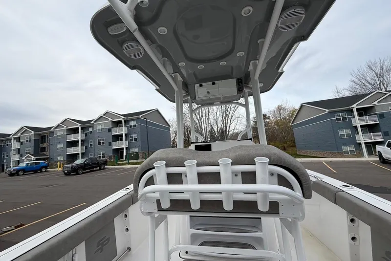 Slide: The Image of 2023 Sea Pro 219 Center Console boat in parking lot, with residential buildings in background. - 47