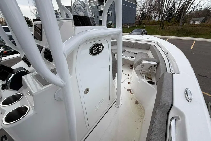 Slide: The Image of 2023 Sea Pro 219 Center Console boat with seating and storage, parked outdoors. - 50