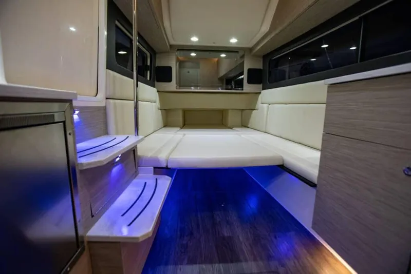 Slide: The Image of Manufacturer Provided Image: Luxurious interior of 2024 Scout 425 LXF boat with ambient blue lighting. - 15
