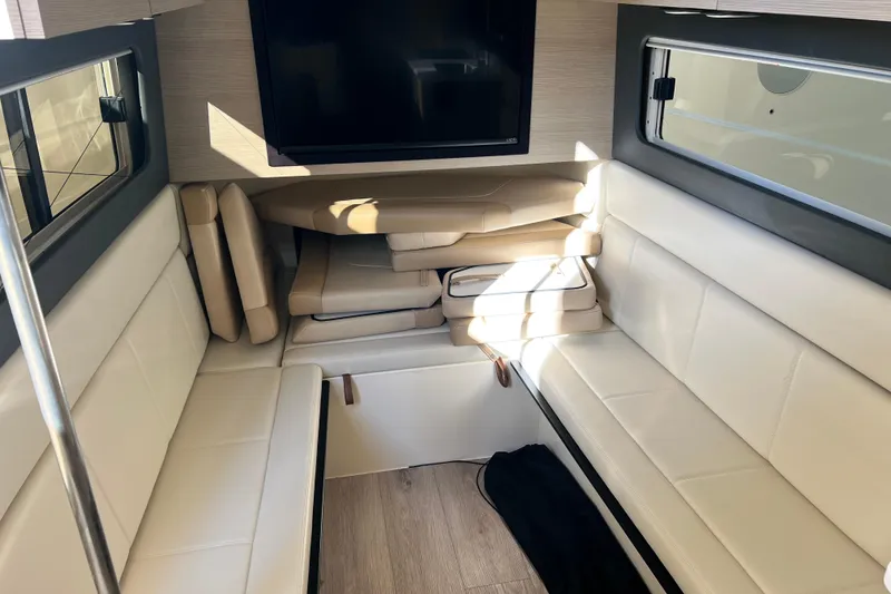 Slide: The Image of 2024 Scout 425 LXF interior with beige seating and a mounted TV. - 20