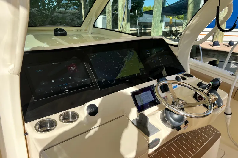 Slide: The Image of 2024 Scout 425 LXF helm with advanced navigation displays and steering wheel. - 21