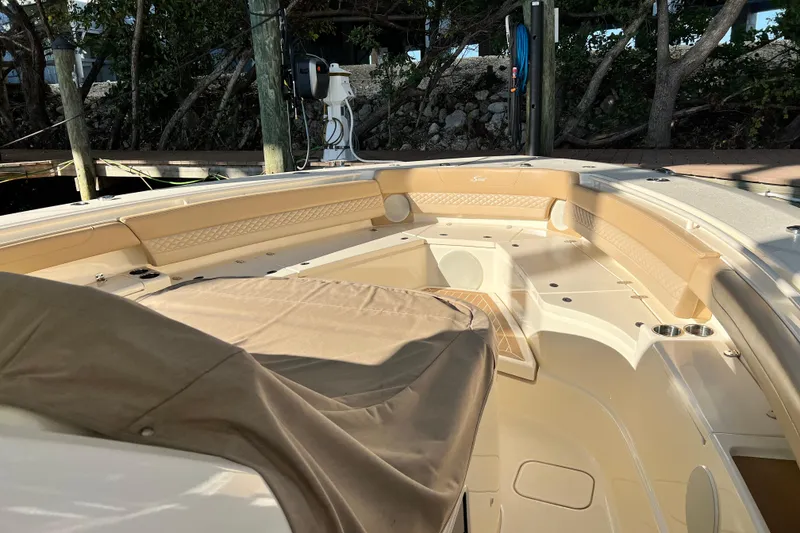 Slide: The Image of 2024 Scout 425 LXF boat interior with tan seating and covered console. - 23