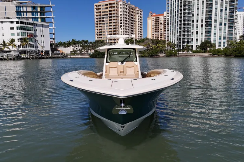 Slide: The Image of 2024 Scout 425 LXF boat on water with city skyline background. - 4