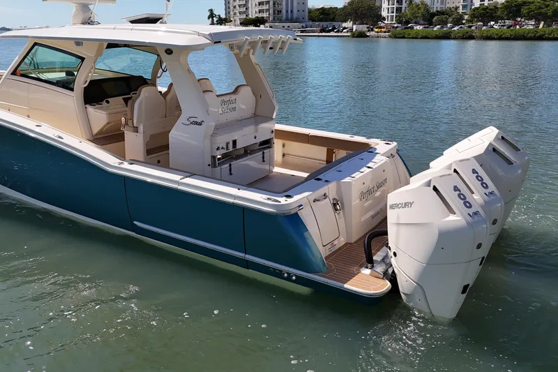 Slide: The Image of 2024 Scout 425 LXF boat with triple Mercury 400 engines on calm water. - 8