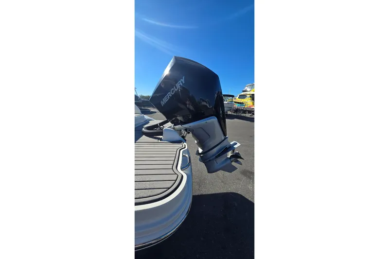 Slide: The Image of 2023 Sea Ray SDX 270 Outboard with Mercury engine, docked under clear blue sky. - 13