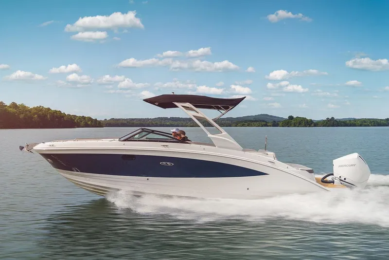 Slide: The Image of Manufacturer Provided Image: 2023 Sea Ray SDX 270 Outboard cruising on a lake under a clear blue sky. - 17