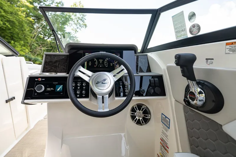 Slide: The Image of Manufacturer Provided Image: 2023 Sea Ray SDX 270 Outboard boat dashboard with steering wheel and control panel. - 23