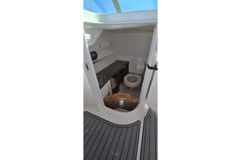 Slide: The Image of 2023 Sea Ray SDX 270 Outboard boat interior with toilet and sink. - 27