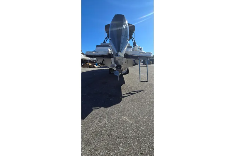 Slide: The Image of 2023 Sea Ray SDX 270 Outboard boat, rear view, parked on asphalt under clear blue sky. - 33