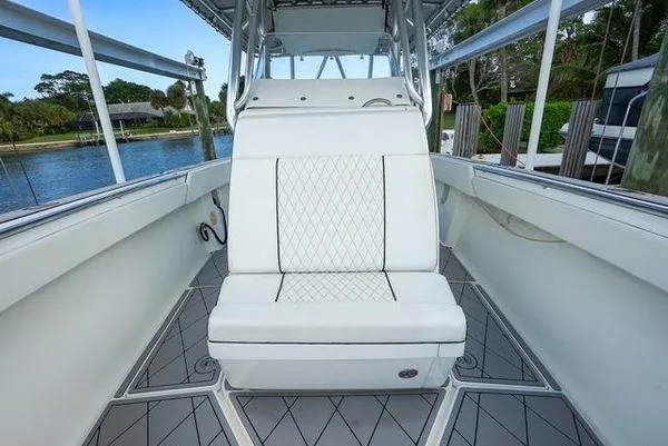 Slide: The Image of 2007 Spectre 37 Center Console boat interior with white seating and waterfront view. - 15