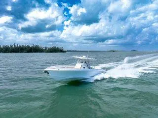 Slide: The Image of 2007 Spectre 37 Center Console boat cruising on open water under cloudy skies. - 2