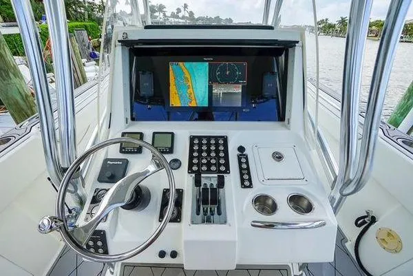 Slide: The Image of 2007 Spectre 37 Center Console boat engine compartment with dual engines visible. - 22